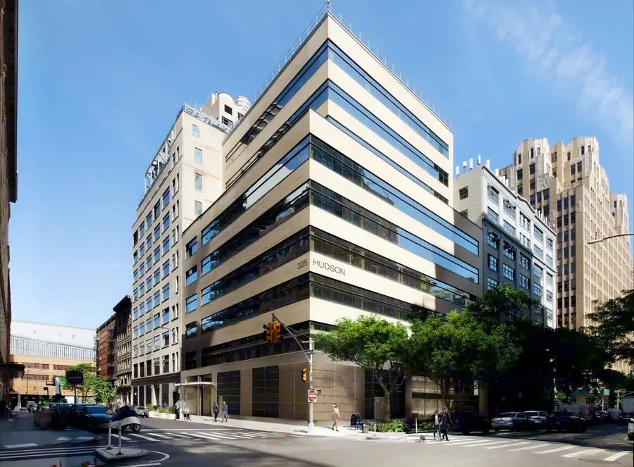 325 Hudson Street, a cream and tan-brick corner building with horizontal glass bands