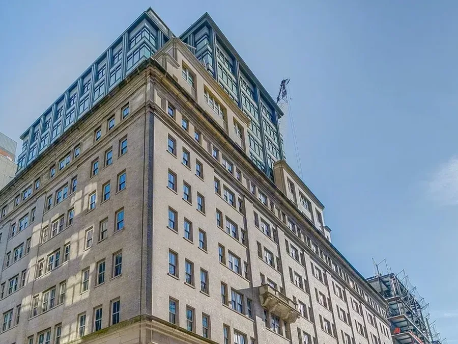330 Hudson Street, detail of the glass-clad crown above the limestone facade