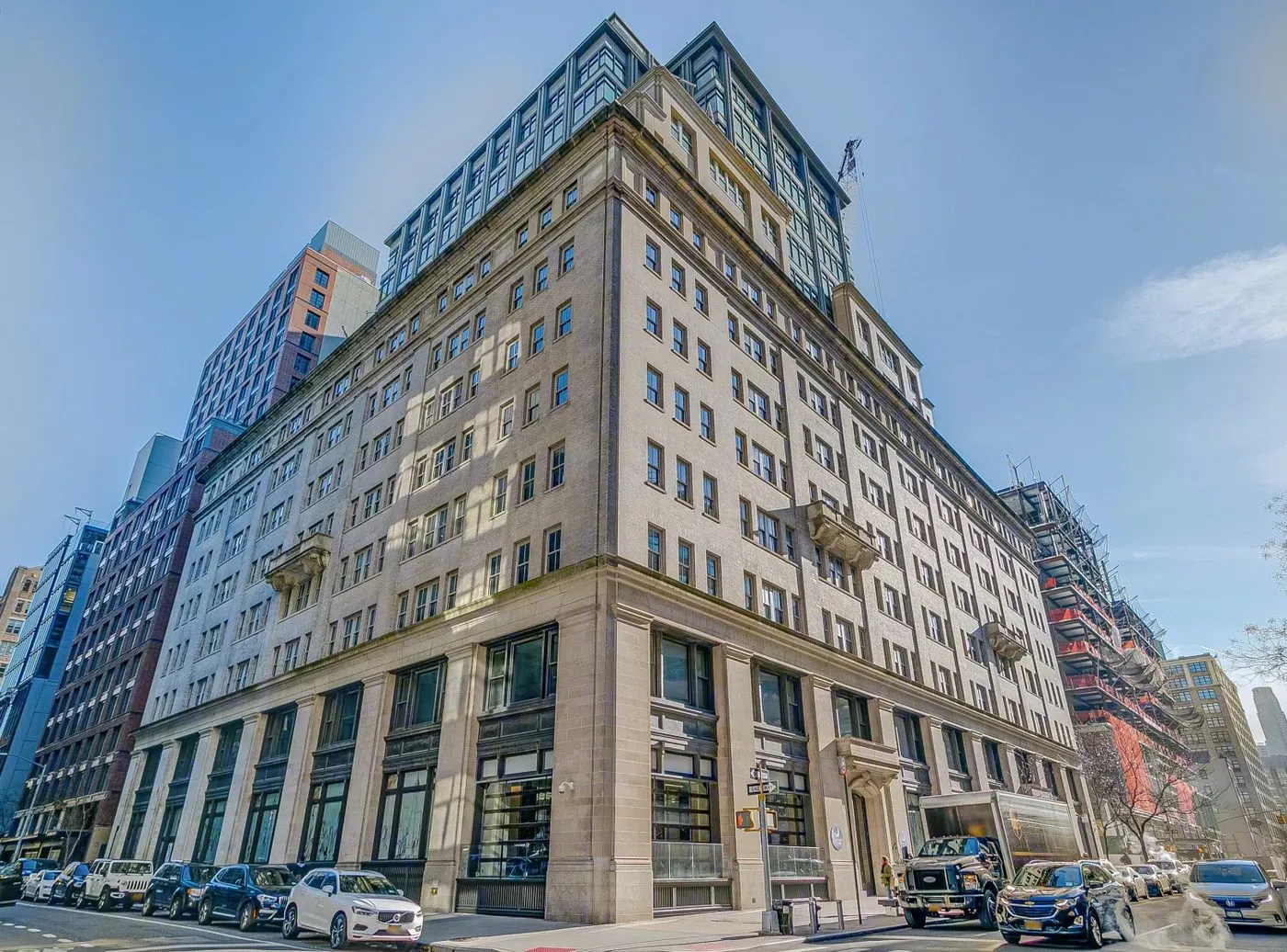 330 Hudson Street in Hudson Square, a limestone-clad corner building with a glass crown